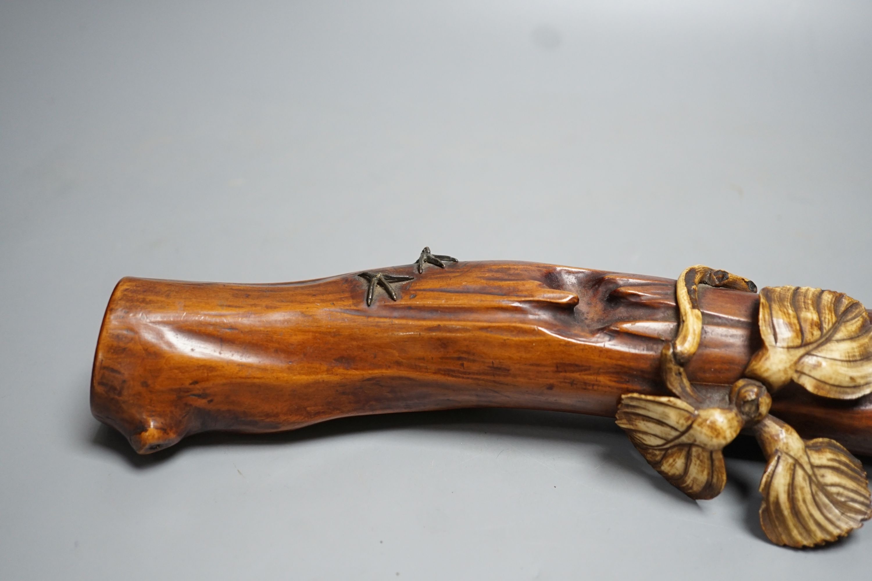 A 19th century Japanese ivory okimono of a kingfisher and log, mother of pearl inset eyes, signed to underside (a.f) 25cm long